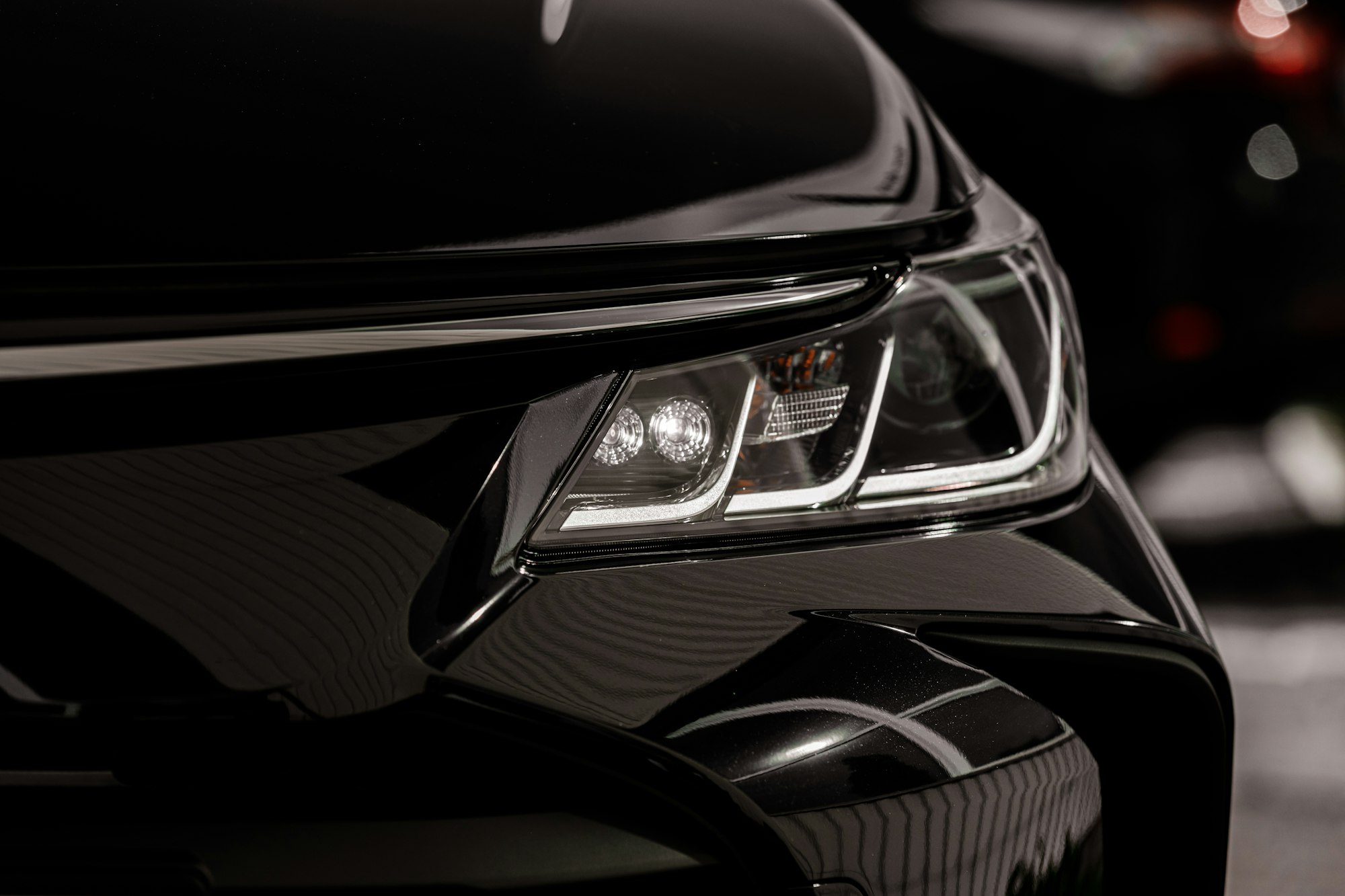 headlight of modern prestigious black car close up.Close up photo of modern car, detail of headlight